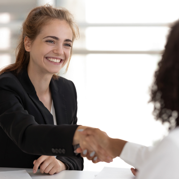 Two women shaking hands after agreeing on hr services